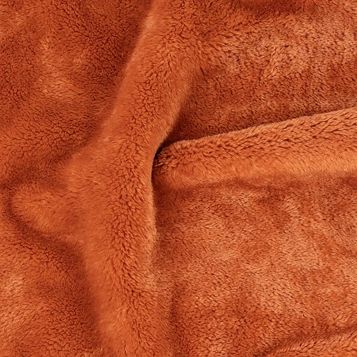 Nahaufnahme von weichem, rostorangem Plüschstoff für professionelle Produktfotografie von Kleidung und Textilien mit hochwertiger Detailstruktur. PRO-ducto GmbH